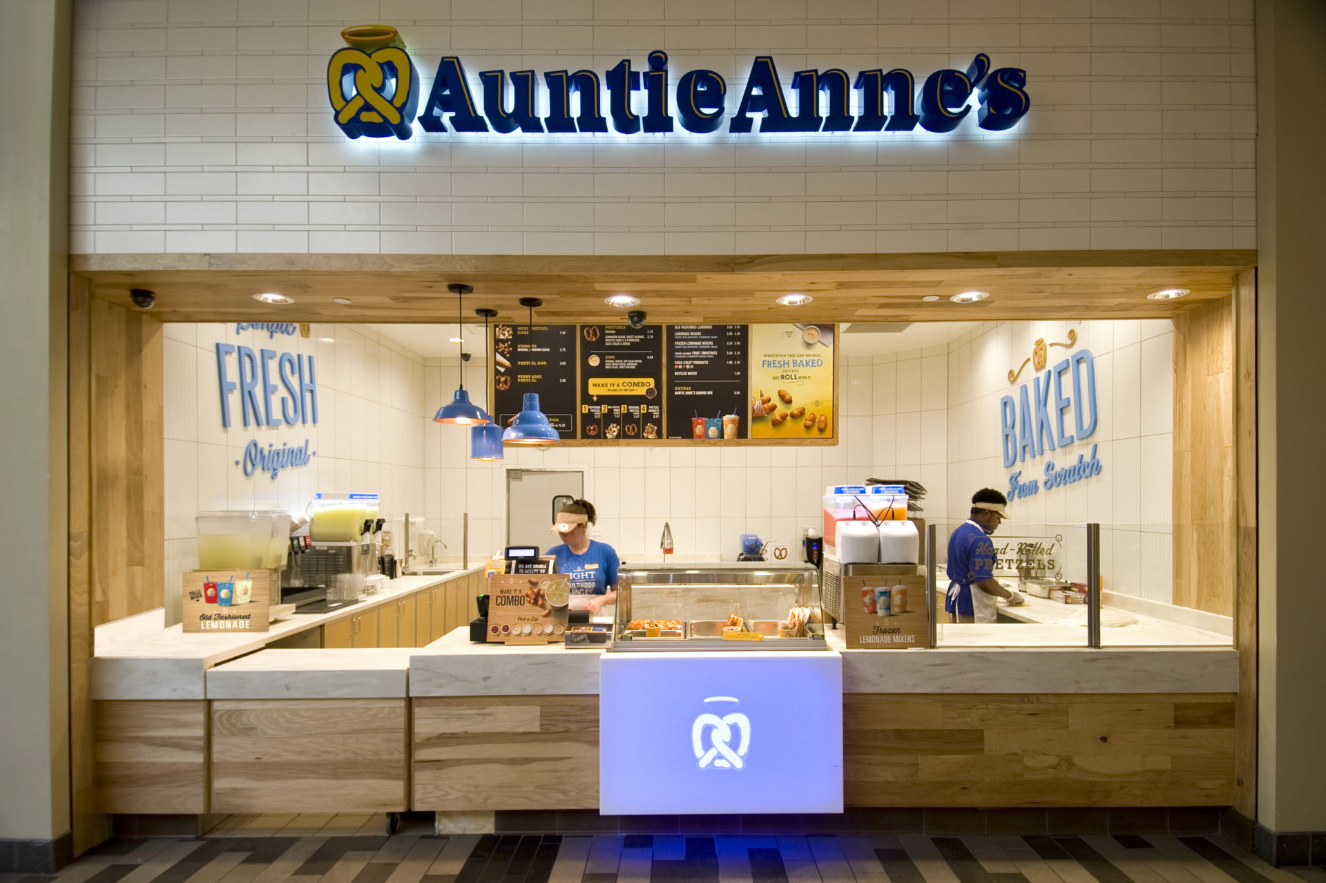 Standing in line at an Auntie Anne's establishment.