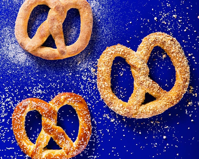 3 Pretzels on a deep blue tabletop